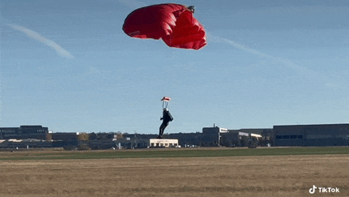 a man is flying through the air with a parachute .