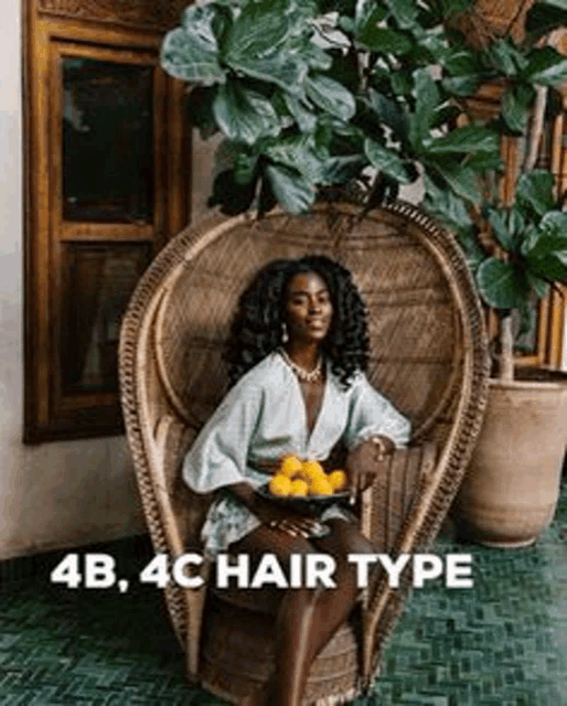 a woman is sitting in a chair holding a bowl of lemons .