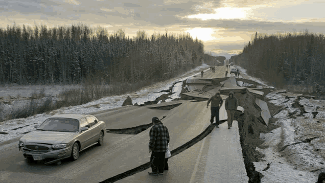 a car is driving down a cracked road with people walking along the side