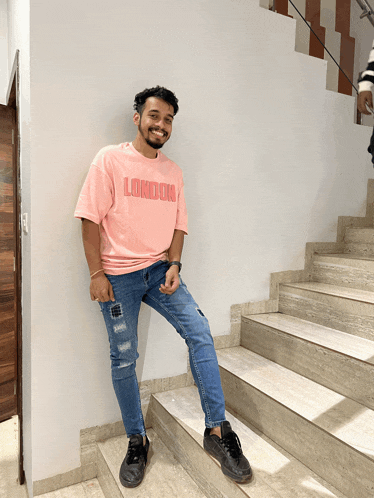 a man wearing a pink t-shirt that says london