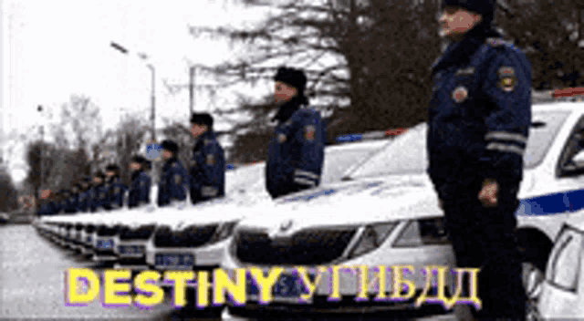 a group of police officers are standing in front of a row of police cars with the words destiny written in yellow