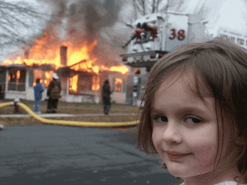 a little girl stands in front of a fire truck with 38 on it