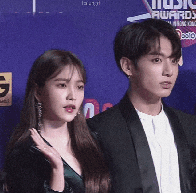 a man and a woman are standing next to each other at a music awards