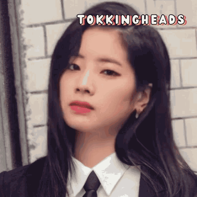 a picture of a woman in a suit and tie with the words tokingheads below her