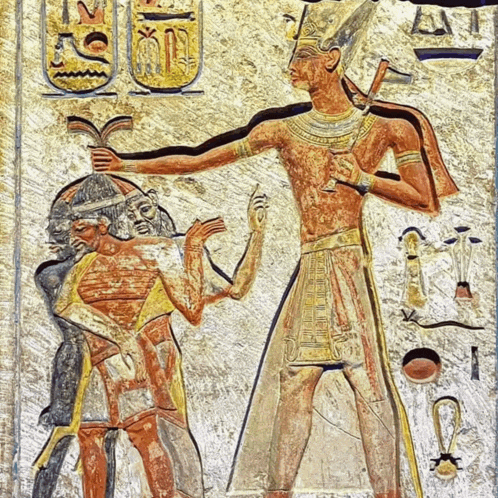 an ancient egyptian painting of a man holding another man 's arm with the letter t on the bottom right