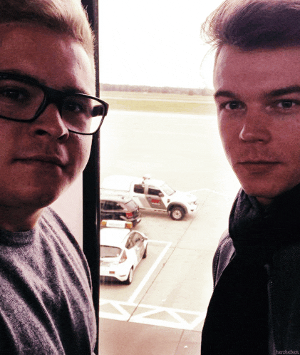 two men are standing next to each other with a car parked in the background and the word harsleben on the bottom