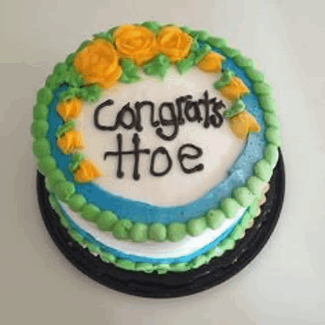 a cake that says congrats hoe on it with yellow roses