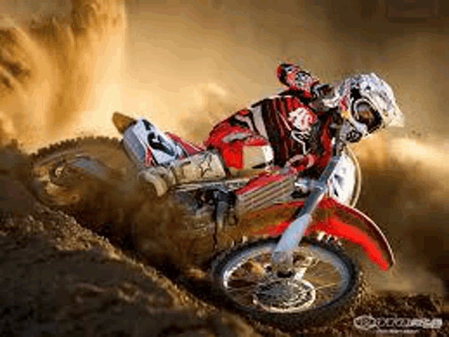 a man is riding a dirt bike on a dirt road .