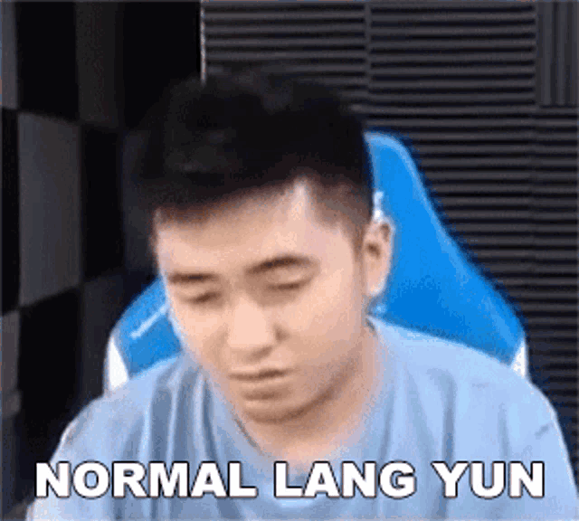 a man is sitting in a chair with his eyes closed and the words `` normal lang yun '' written on the screen .