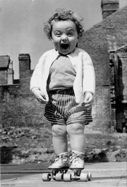 a black and white photo of a little girl on roller skates