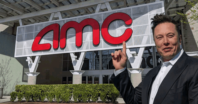 a man stands in front of an amc building