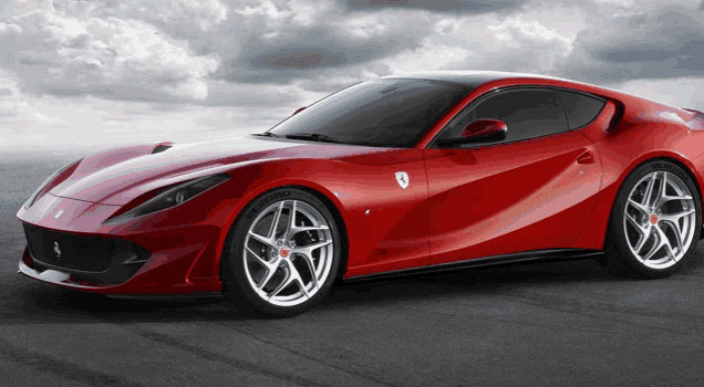 a red ferrari sports car is parked on the street