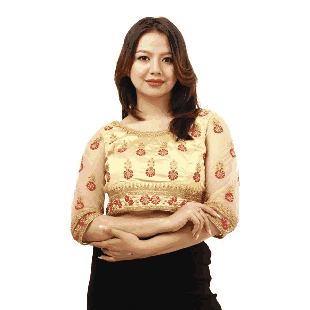 a woman wearing a yellow blouse with red flowers on it