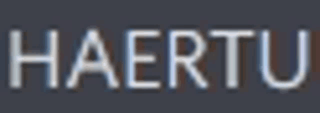 the word haertu is written in a blurred font on a dark background .