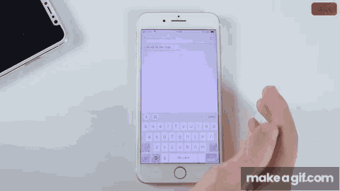 a person is typing on a cell phone with make a gif.com written on the bottom