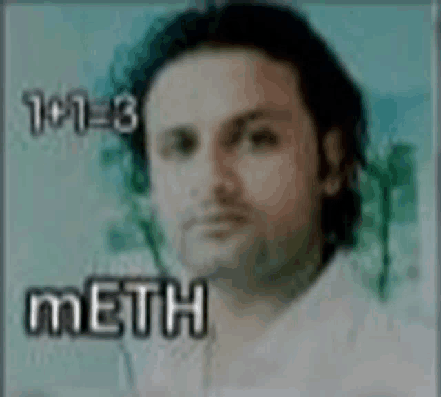 a man in a white shirt is standing in front of a wall with the word meth on it .