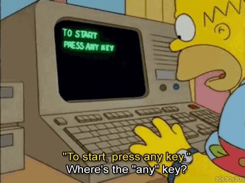 homer simpson is looking at a computer screen that says " to start press any key where 's the any key "