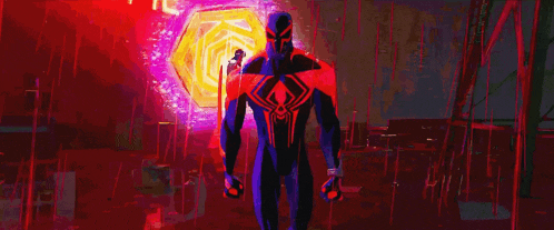 a man in a spiderman suit is standing in a dark room with a purple light behind him .