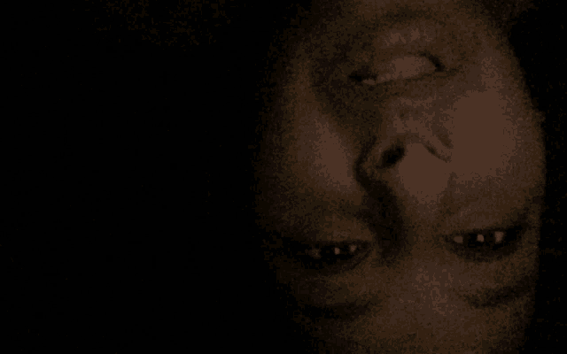 a close up of a person 's face with a black background