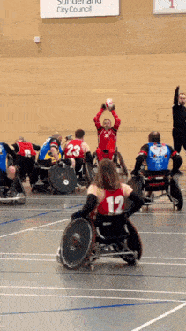 a group of people in wheelchairs are playing a game in front of a sign that says sundern city council