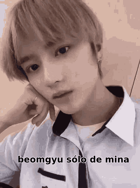 a close up of a person 's face with the words beomgyu solo de mina on it