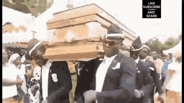 a man in a black suit is carrying a coffin while dancing .