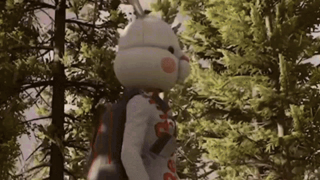 a stuffed bunny with a backpack is standing in the woods