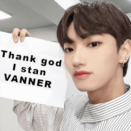 a young man is holding up a sign that says thank god i stan vanner