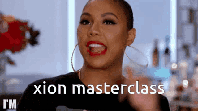 a woman with red lipstick and hoop earrings says xion masterclass