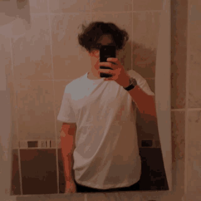 a man taking a selfie in front of a mirror