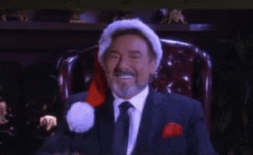 a man in a suit and tie with a santa hat on