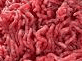 a pile of raw ground beef is sitting on top of a table .