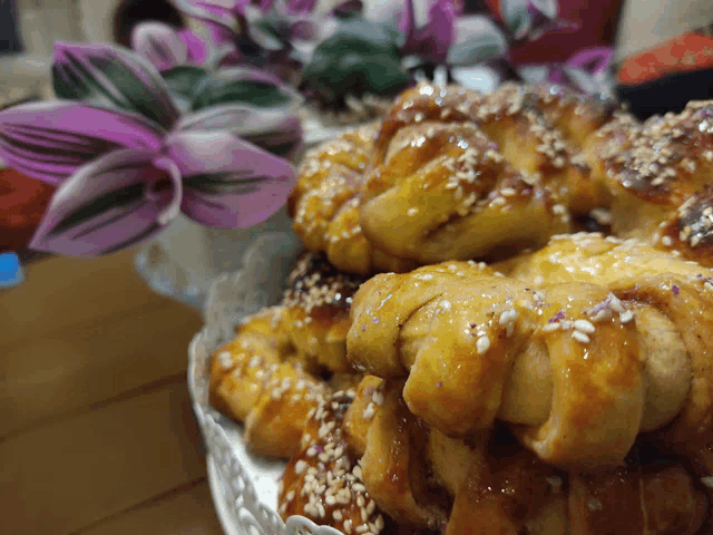 a tray of pastries with sesame seeds on top