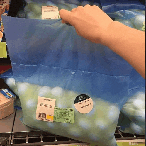 a person is holding a bag of pea-sized baked eggs