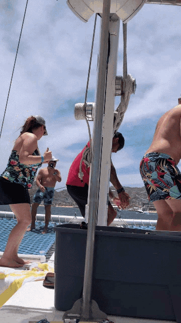 a group of people on a boat including a man in a red shirt and a woman in a floral top