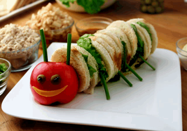 a caterpillar made out of sandwiches and an apple