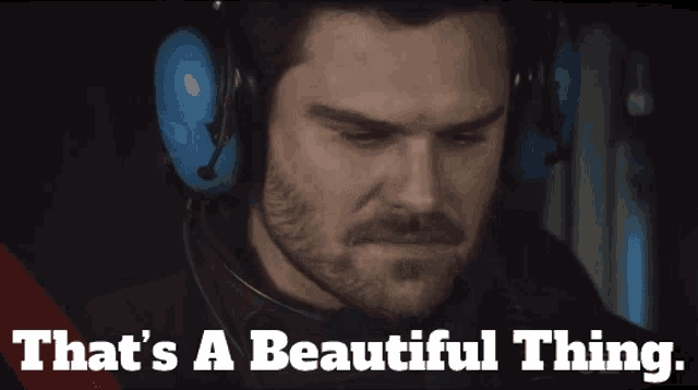 a man wearing headphones with the words that 's a beautiful thing below him