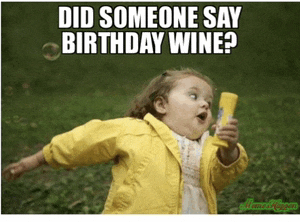 a little girl in a yellow jacket blowing soap bubbles with a caption that says did someone say birthday wine