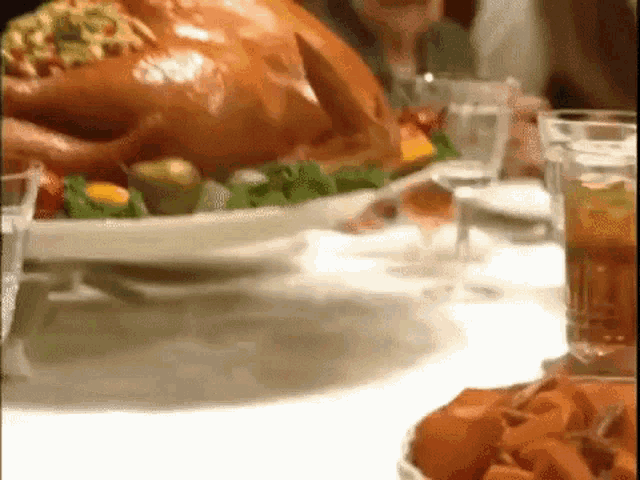 a turkey is sitting on a plate on a table with other food