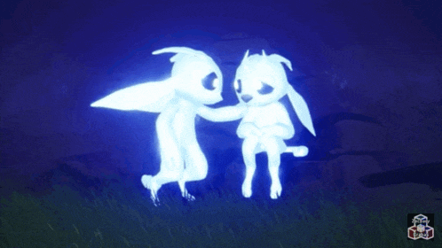 two glowing rabbits are standing next to each other in the dark