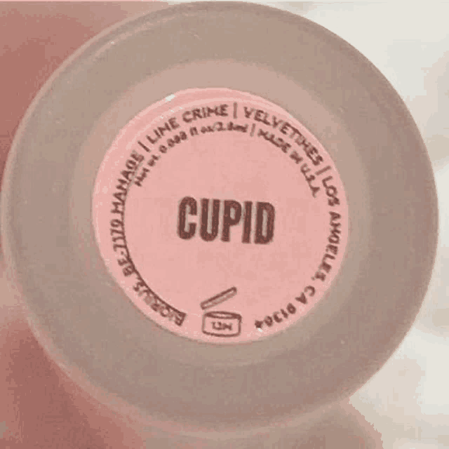 a close up of the bottom of a cupid perfume bottle