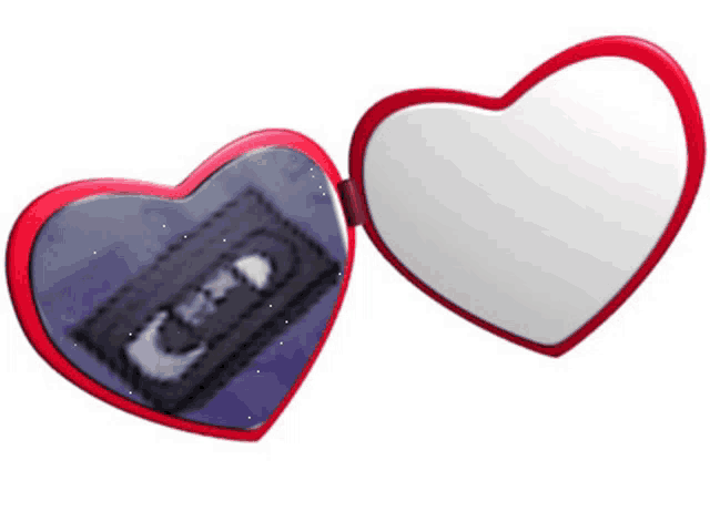 a heart shaped mirror shows a vhs tape