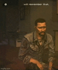 a man with a beard is sitting in a dark room in a video game