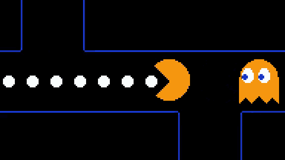 a row of pac man ghosts are lined up on a dark background