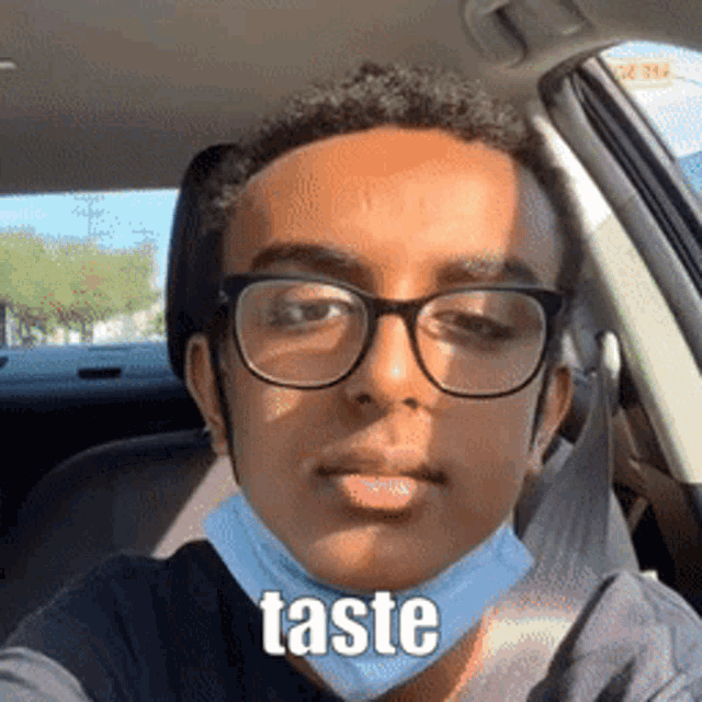 a young man wearing glasses and a face mask has the word taste on his face