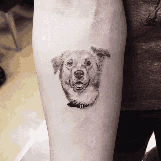 a person has a tattoo of a dog on their forearm