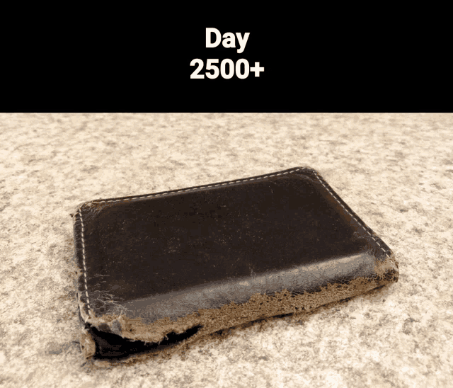 a black wallet with the words day 2500+ written on the bottom