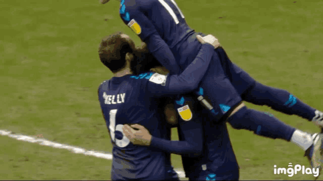 a soccer player with the number 6 on his back is being lifted by his teammates