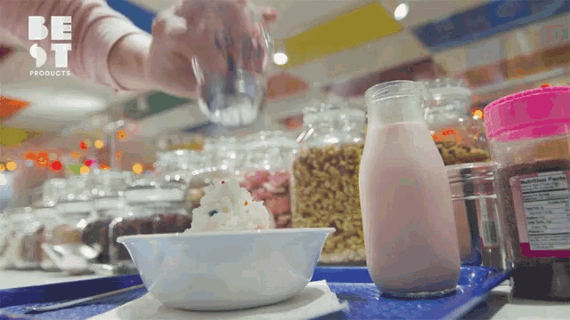 a person pouring a glass of water into a bowl of ice cream with a be st products logo in the background