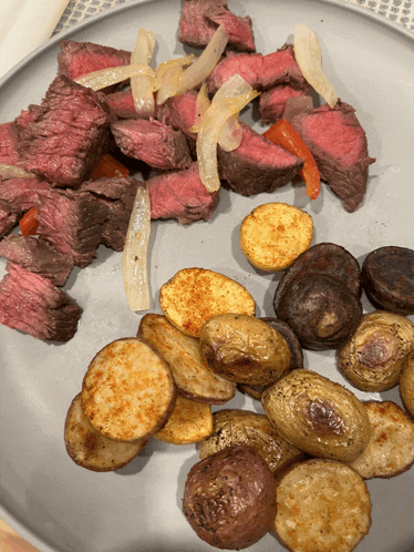 a plate of food with potatoes and meat on it